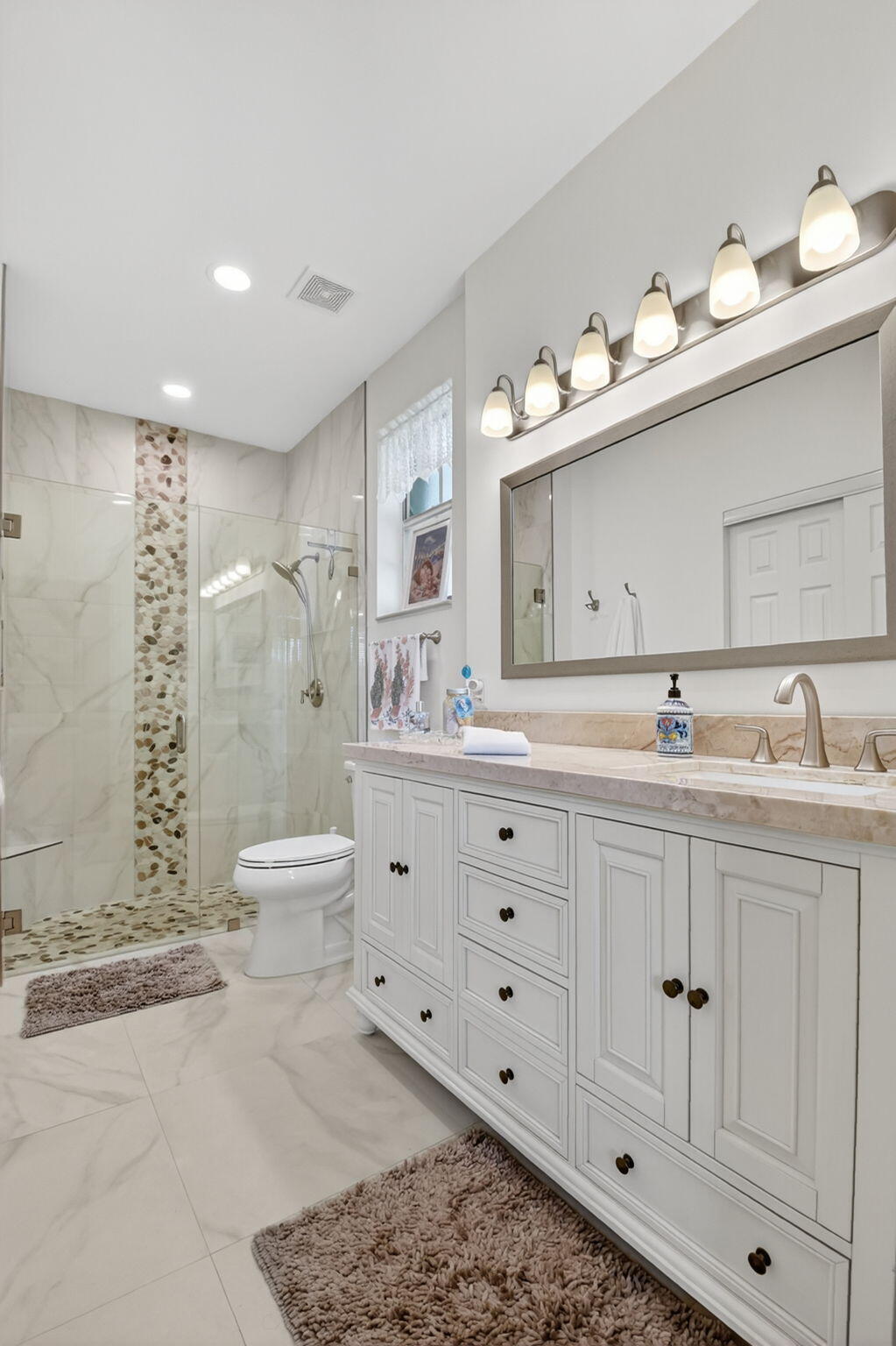 6210 Heliconia Road Delray Beach, FL 33484 - Photo 34 of 53 a bathroom with double vanity sink and mirror