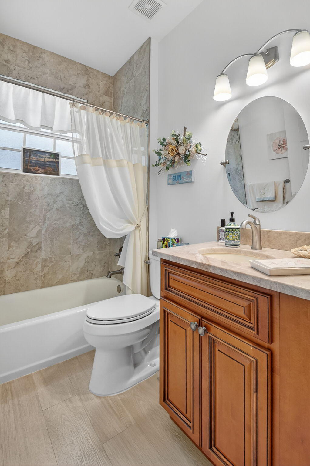 6210 Heliconia Road Delray Beach, FL 33484 - Photo 40 of 53 a bathroom with a sink a toilet and a mirror