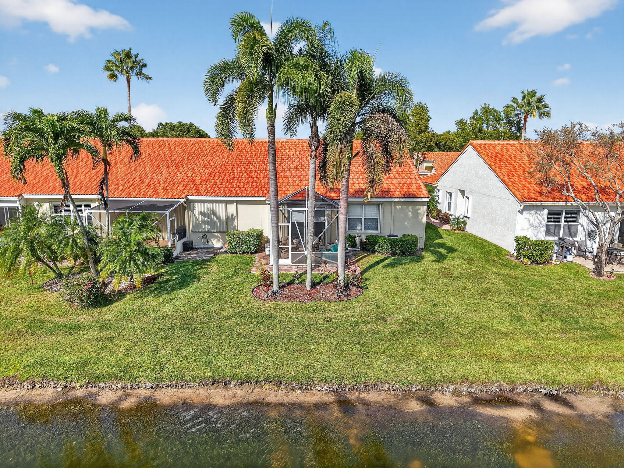 6210 Heliconia Road Delray Beach, FL 33484 - Photo 52 of 53 a view of a palm trees in front of a house