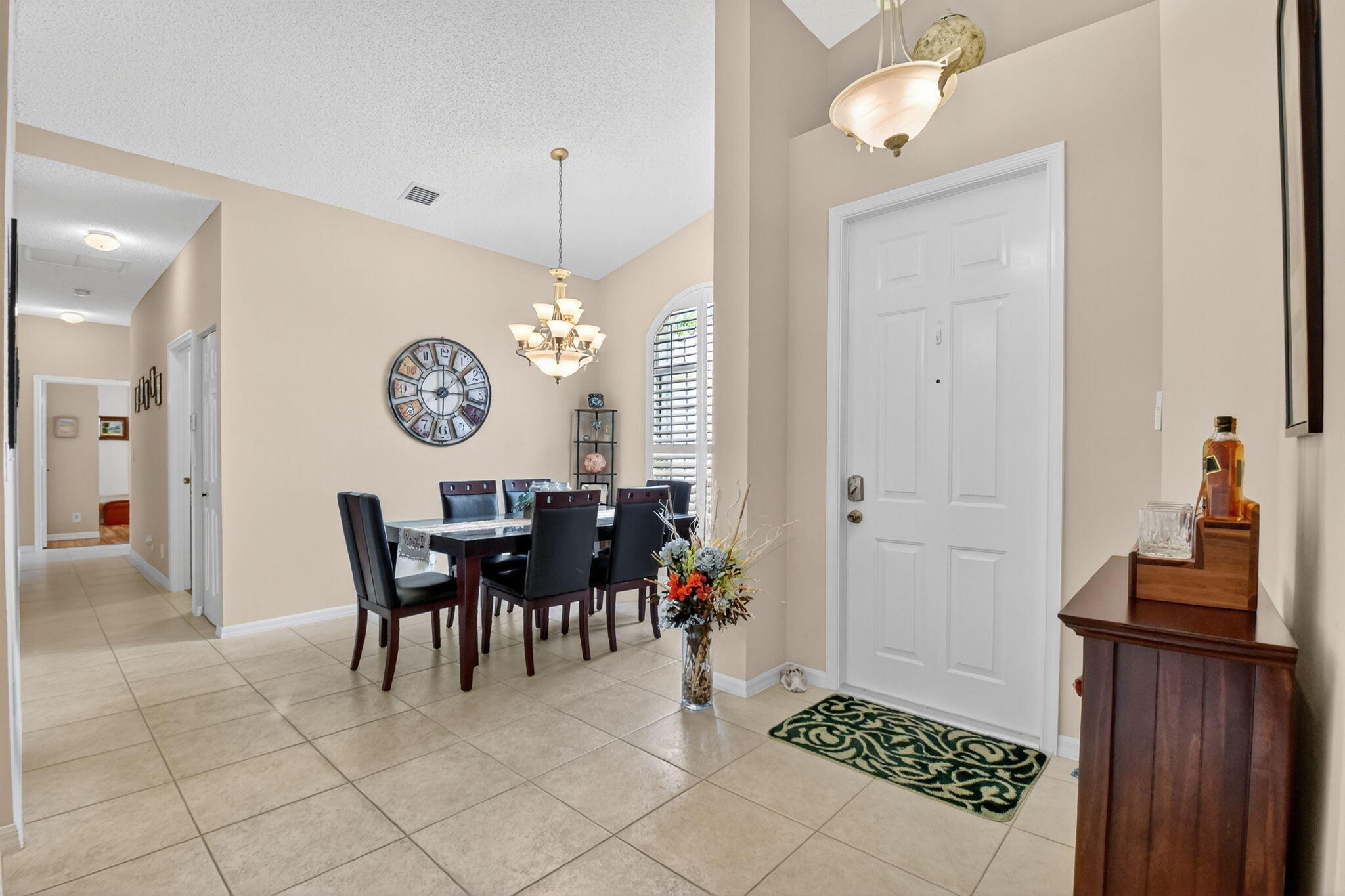 6210 Heliconia Road Delray Beach, FL 33484 - Photo 8 of 53 a view of a dining area with furniture and chandelier