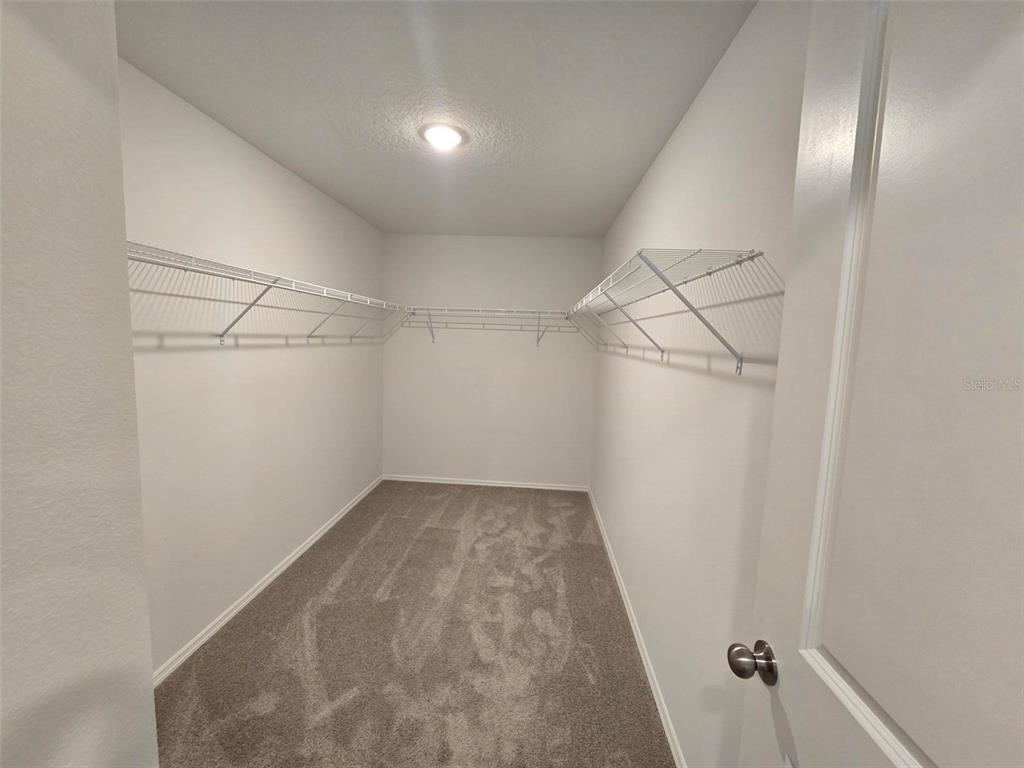 13031 Bluff Oak Way Parrish, FL 34219 - Photo 11 of 25 a view of a room with racks on the wall