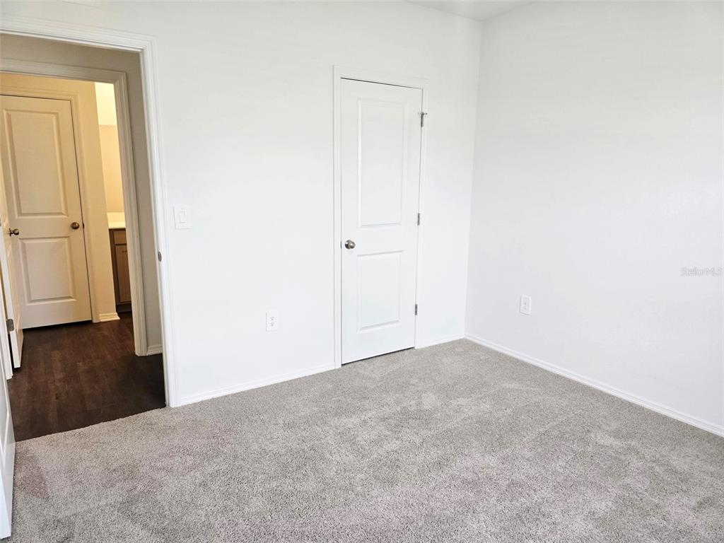13031 Bluff Oak Way Parrish, FL 34219 - Photo 14 of 25 a view of a big room with closet and wooden floor