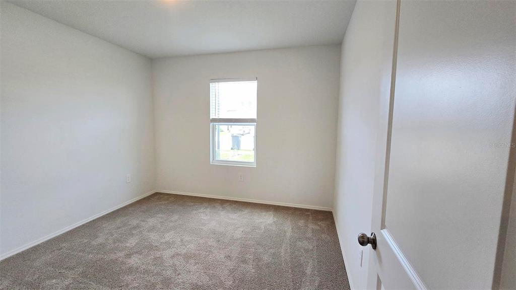 13031 Bluff Oak Way Parrish, FL 34219 - Photo 16 of 25 an empty room with a window