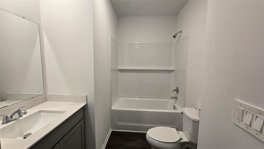 13031 Bluff Oak Way Parrish, FL 34219 - Photo 17 of 25 a bathroom with a sink toilet and bathtub