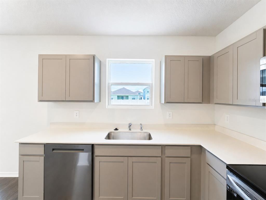 13031 Bluff Oak Way Parrish, FL 34219 - Photo 5 of 25 a kitchen with a sink cabinets and a window