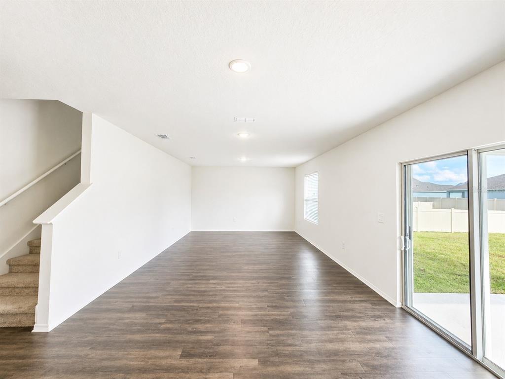 13031 Bluff Oak Way Parrish, FL 34219 - Photo 6 of 25 a view of empty room with wooden floor