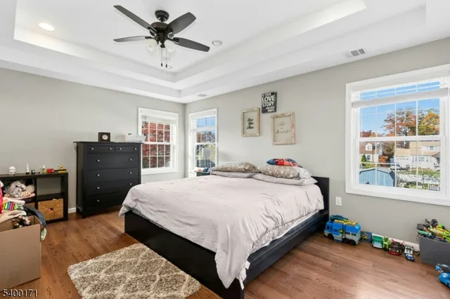 a bedroom with a bed dresser and a window