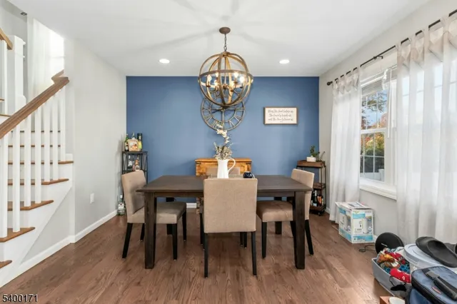 a view of a dining room with furniture wooden floor and a chandelier