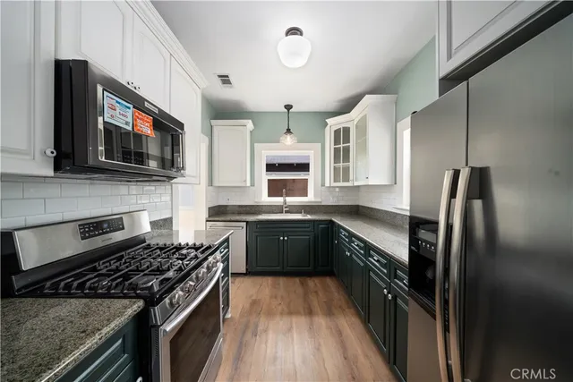 a kitchen with a stove a sink and a microwave