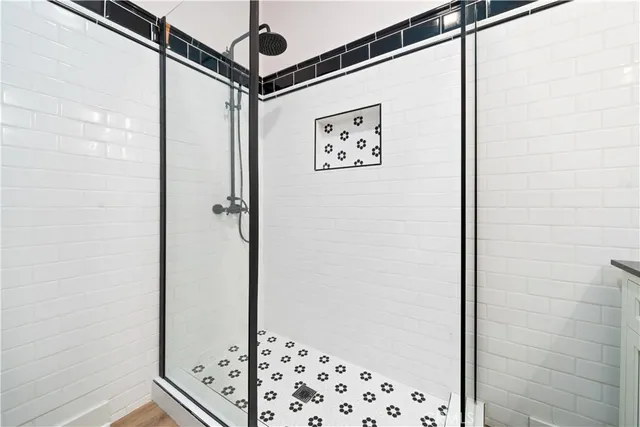a bathroom with a shower and a sink
