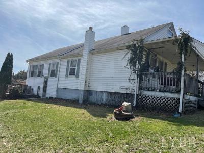 1368 Stone Mill Road Hurt, VA 24563 - Photo 1 of 17 a front view of a house with a yard table and chairs