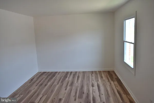a view of room with window and hardwood floor