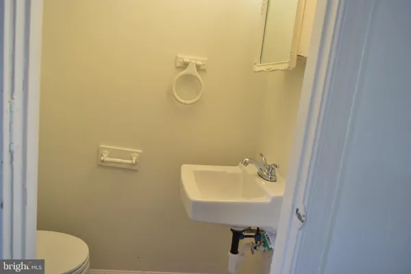 a bathroom with a sink a mirror and a toilet