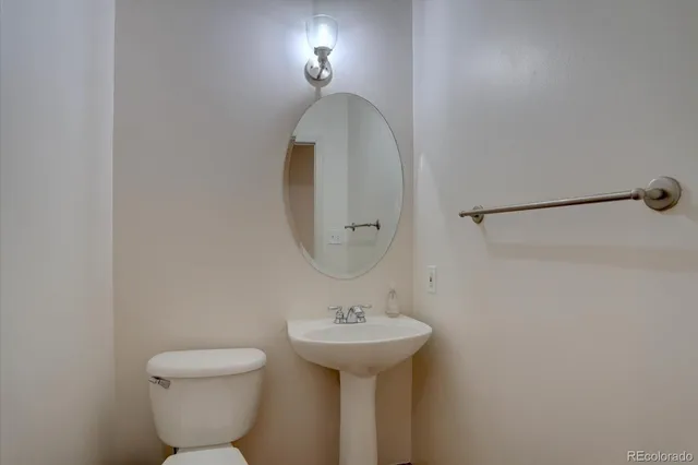 a bathroom with a sink a mirror and a toilet