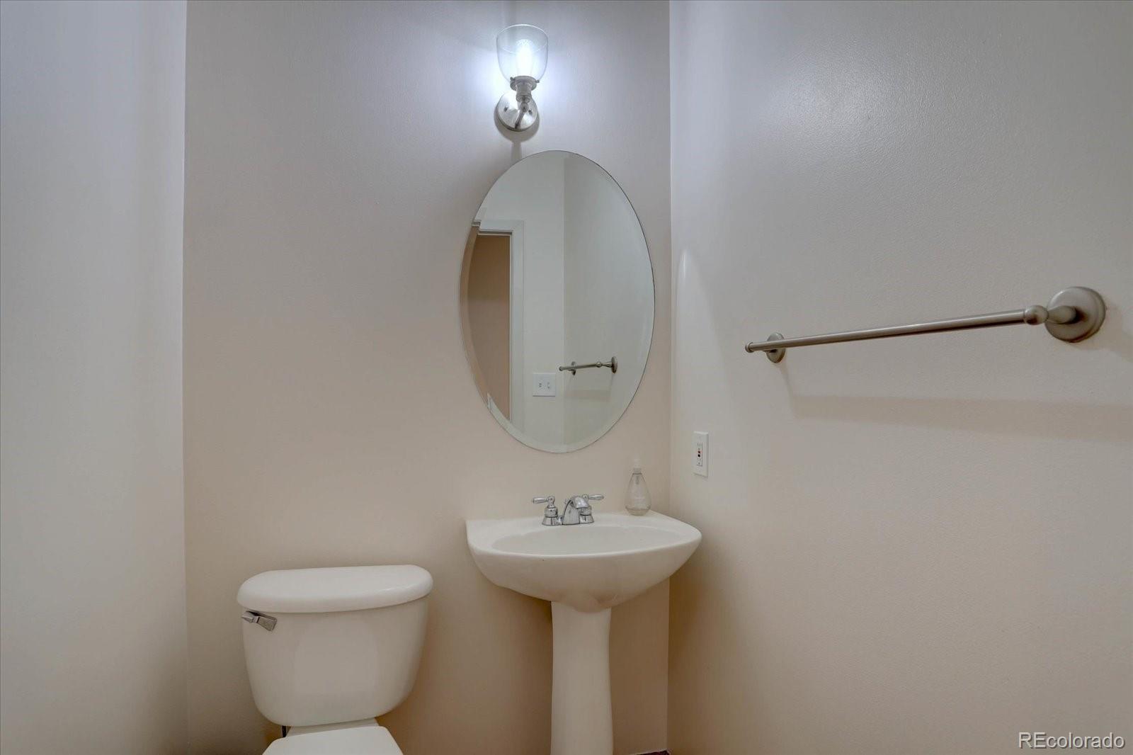2960 Inca Street, Unit 416 Denver, CO 80202 - Photo 14 of 16 a bathroom with a sink a mirror and a toilet