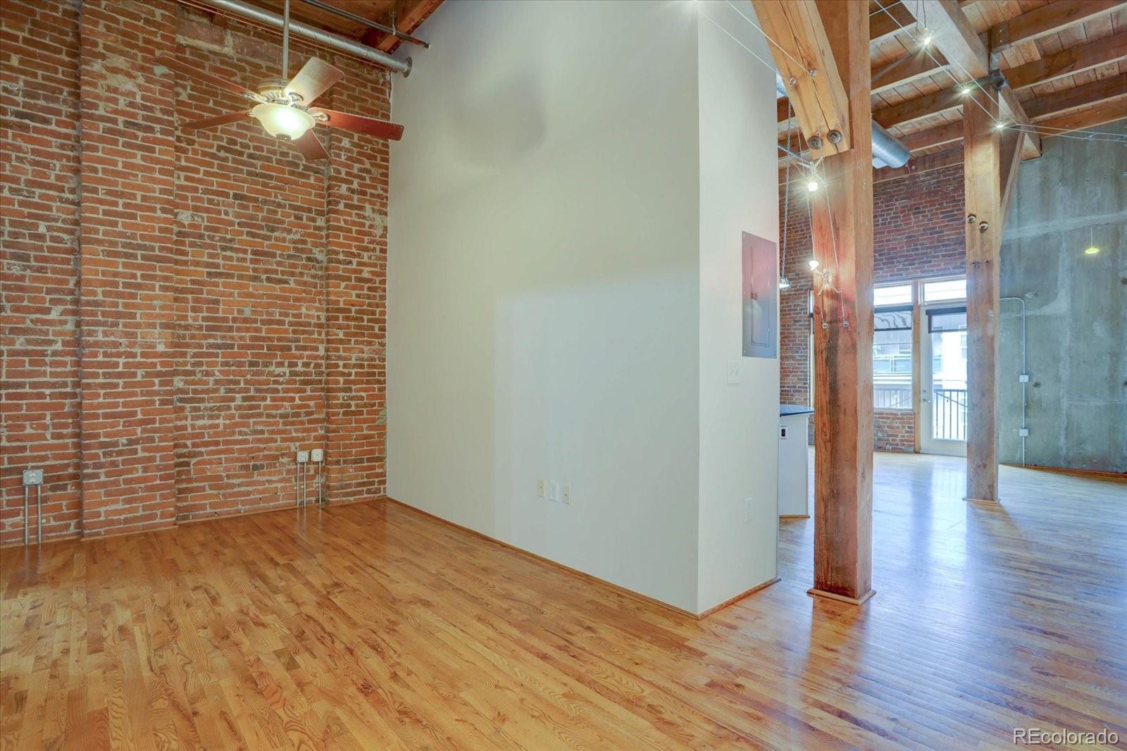 2960 Inca Street, Unit 416 Denver, CO 80202 - Photo 4 of 16 a view of a hallway with wooden floor and a bathroom