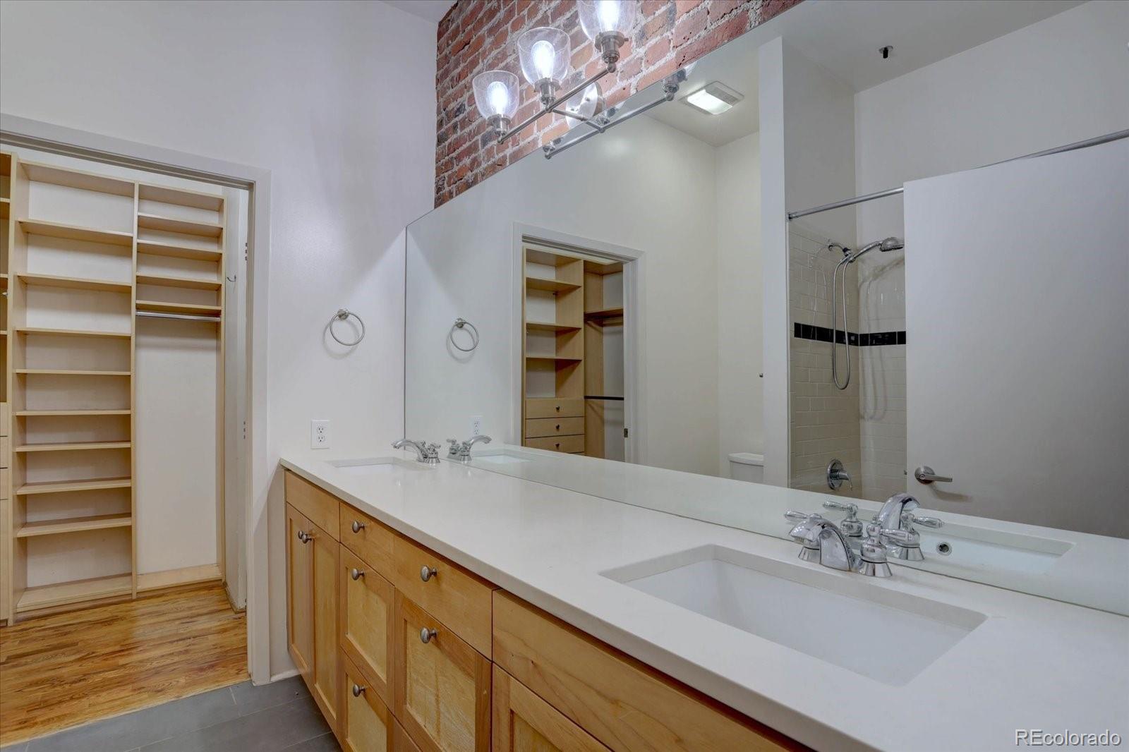 2960 Inca Street, Unit 416 Denver, CO 80202 - Photo 6 of 16 a bathroom with a double vanity sink and a mirror