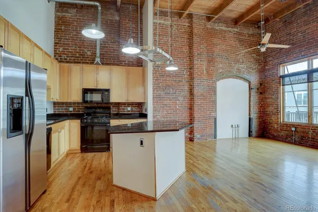 a kitchen with stainless steel appliances a refrigerator and a stove
