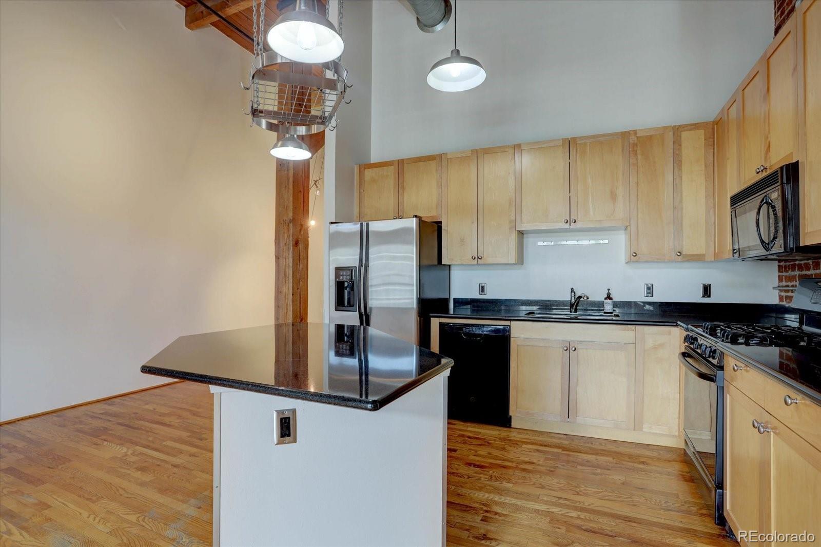 2960 Inca Street, Unit 416 Denver, CO 80202 - Photo 10 of 16 a kitchen with stainless steel appliances granite countertop a sink a stove and a refrigerator