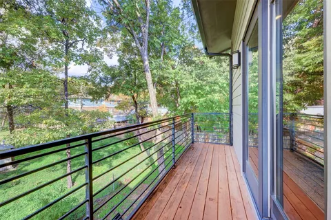 a view of balcony with wooden floor