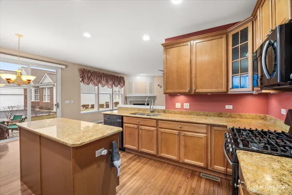 a kitchen with a sink stove and cabinets