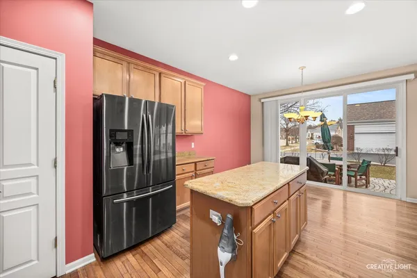 a kitchen with a refrigerator a sink and wooden cabinets