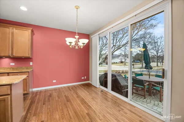 a view of a livingroom with furniture wooden floor and chandelier
