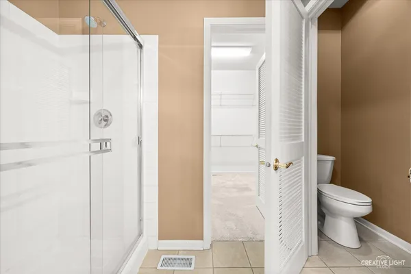 a bathroom with a shower and a toilet