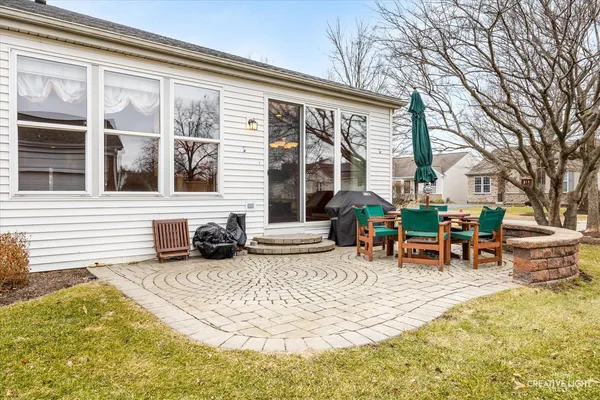 a view of a house with swimming pool and sitting area