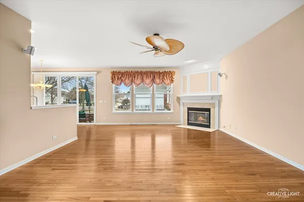 a view of an empty room with a window and fireplace