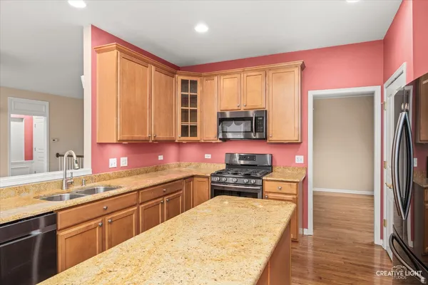 a kitchen with stainless steel appliances a stove sink and cabinets