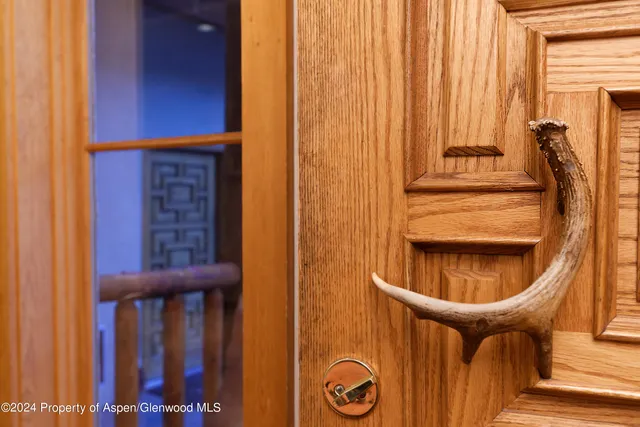 a dining room with furniture a chandelier and window