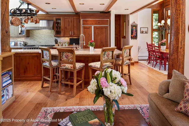 a living room with furniture a rug and a large window