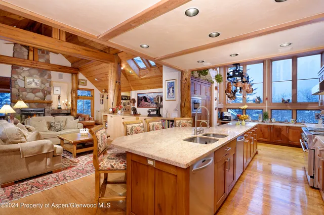 a spacious bathroom with a granite countertop double vanity sink a mirror a shower and a bathtub