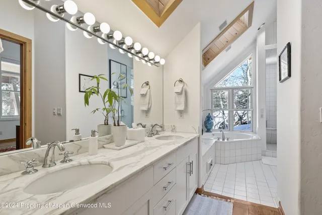 a bedroom with a bed tv and a window