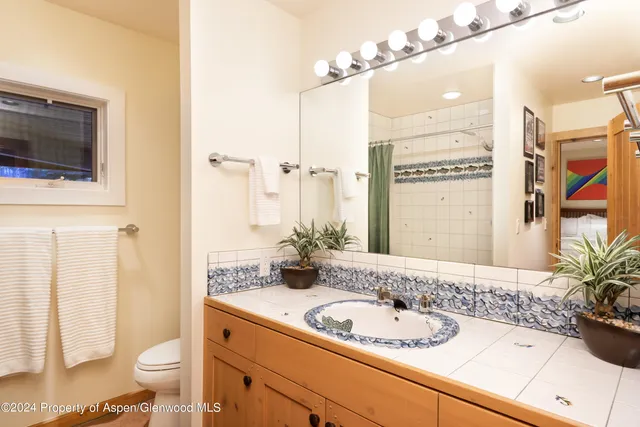 a living room with furniture a rug and a large window