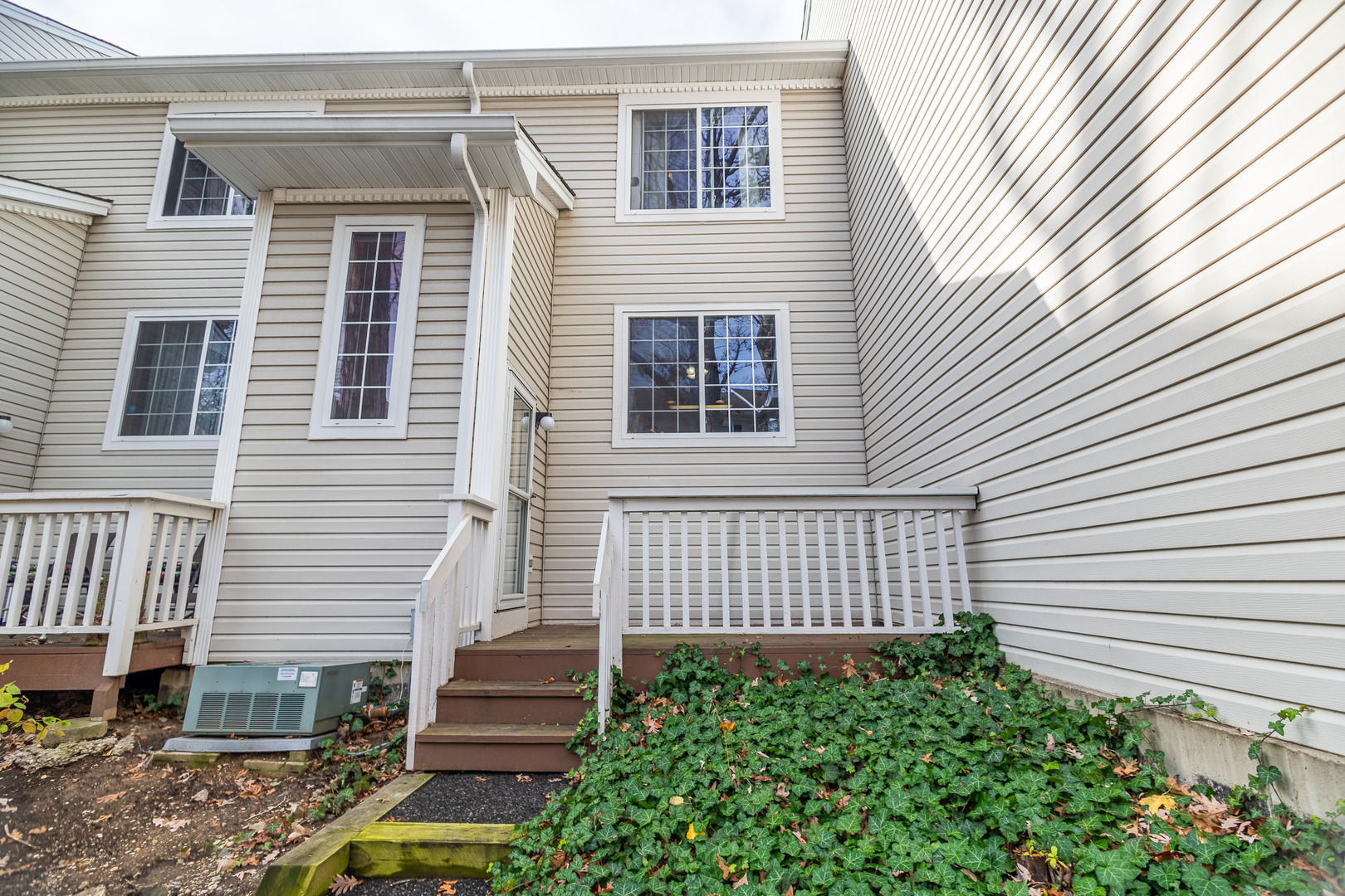307 West Treehouse Lane, Unit 307 Round Lake, IL 60073 - Photo 1 of 1 a front view of a house with a garden