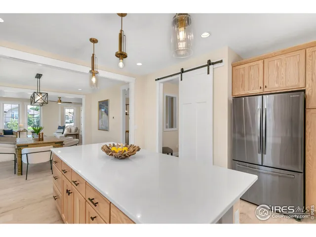 a kitchen with stainless steel appliances granite countertop a refrigerator a sink and a refrigerator