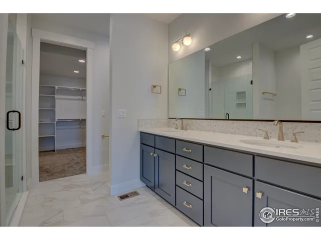 a bathroom with a granite countertop sink a toilet and shower