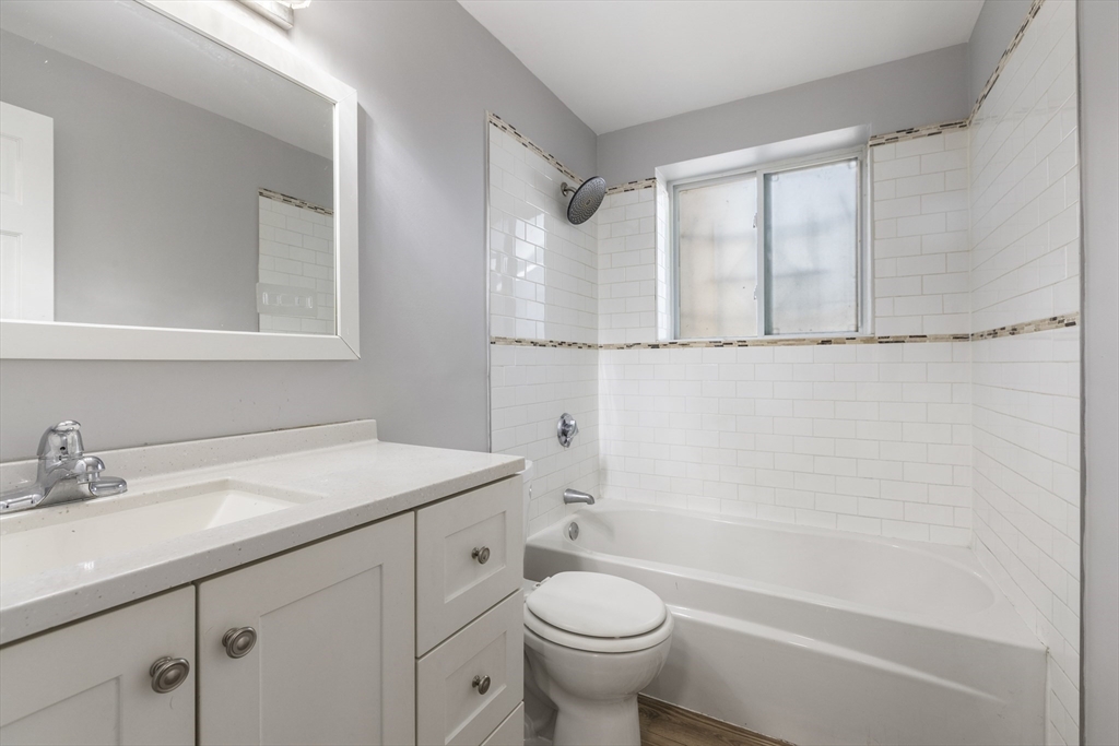 96 Itasca Street, Unit 961 Boston, MA 02126 - Photo 11 of 18 a bathroom with a sink a toilet and a bathtub