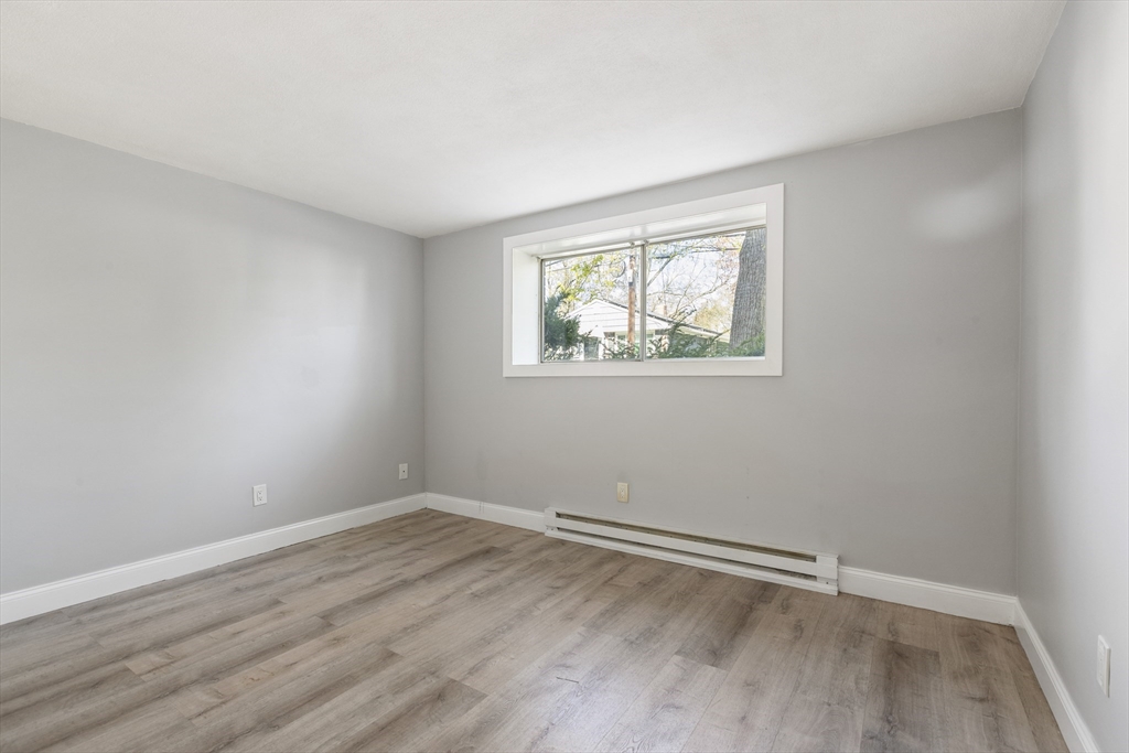 96 Itasca Street, Unit 961 Boston, MA 02126 - Photo 13 of 18 an empty room with wooden floor and windows
