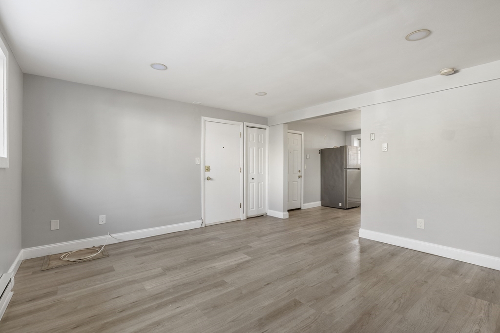 96 Itasca Street, Unit 961 Boston, MA 02126 - Photo 8 of 18 a view of an empty room with wooden floor