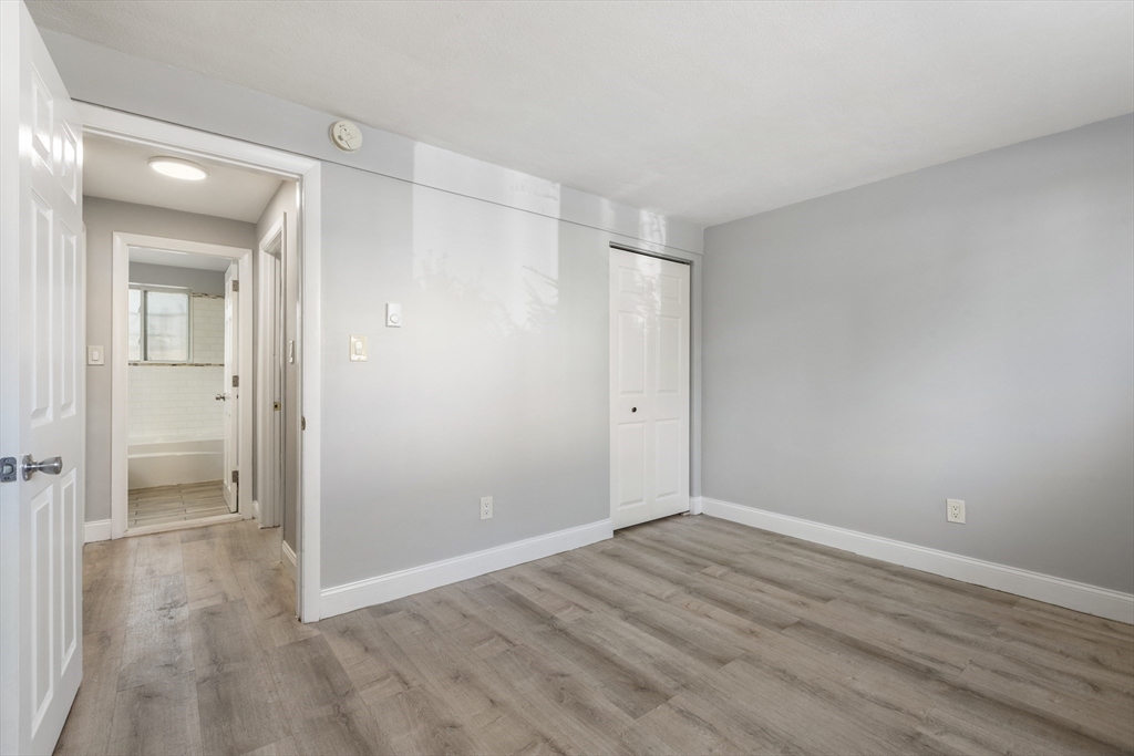 96 Itasca Street, Unit 961 Boston, MA 02126 - Photo 10 of 18 wooden floor in an empty room