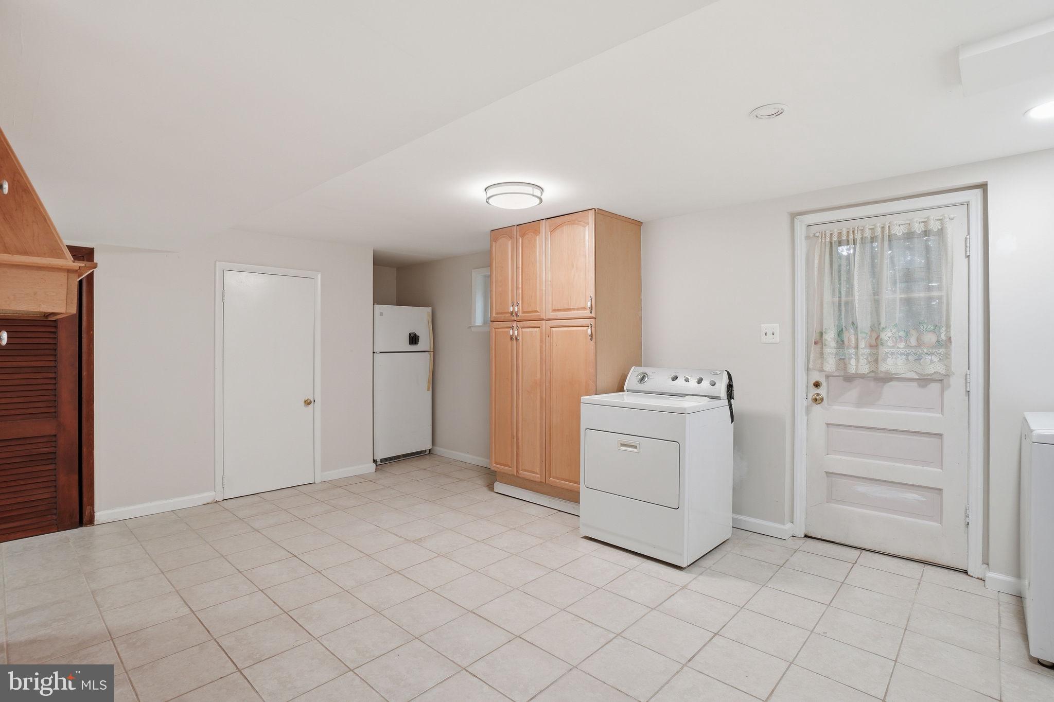 5304 Pillow Lane Springfield, VA 22151 - Photo 23 of 32 a utility room with cabinets washer and dryer