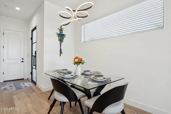 a view of a dining room with furniture and wooden floor