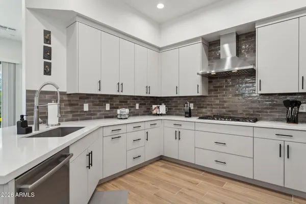 a kitchen with granite countertop white cabinets and white appliances