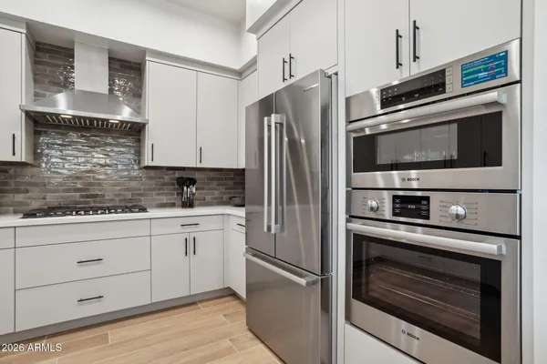 a kitchen with granite countertop stainless steel appliances and wooden cabinets