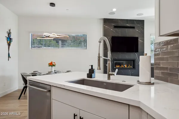 a kitchen with a sink cabinets and a fireplace