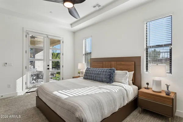 a bedroom with a bed and a large window