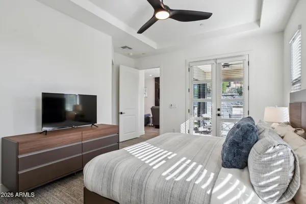 a bedroom with a bed and a flat screen tv